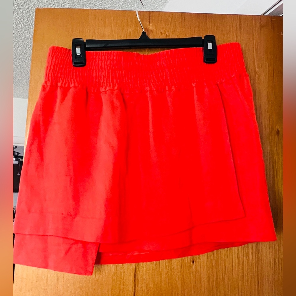 Acne Studios orange skirt. Asymmetrical layered material.